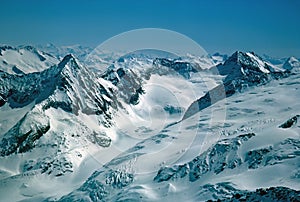 Panorama of snowy mountains and high alpine peaks in wintery Bernese Oberland in Switzerland