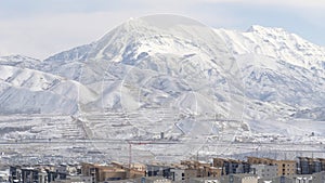 Panorama Snowy Wasatch Mountain towering over the neighborhood of South Jordan in Utah