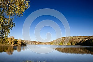 Panorama of Sotsko Jezero, or lake Sot, in Fruska Gora, in Serbia, Europe, in summer, at dusk, into the light.