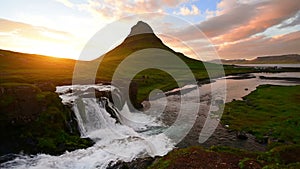 Panorama Spring in western Iceland Kirkyufetl mountain waterfall cascades at sunset