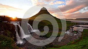 Panorama Spring in western Iceland Kirkyufetl mountain waterfall cascades at sunset