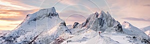 Panorama of Steep peak mountains with covered snow and mountaineer man backpacker