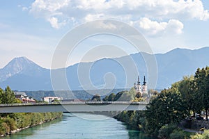 Panorama of the suburbs of Villach with a selective blur on the steeple clocktower of pfarramt heiligenkreuz Kirche, or the Parish