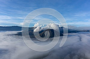 Panorama sunrise view of Mount Bromo, still active volcano and part of the Tengger massif with mist and cloud from vocalno crater