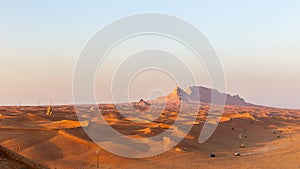 Panorama of sunset over Fossil Rock mountain ridge and golden desert dunes, Sharjah, United Arab Emirates