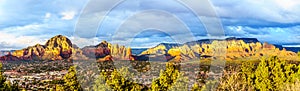 Panorama of a Sunset over Thunder Mountain and other red rock mountains surrounding the town of Sedona, Arizona