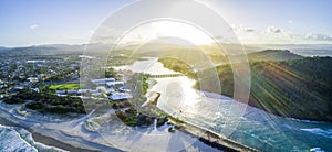 Panorama of sunset with sun flare over Tallebudgera creek in Gold Coast.