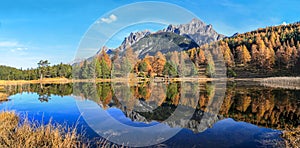 Panorama of the Swiss Alps mountain lake Lai Nair Black Lake with refleciton photo