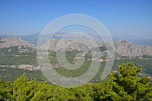 Panorama of the Taurus Mountains on the background of a summer blue sky on a sunny day near Antalya, Turkey