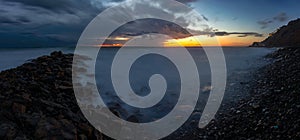 Panorama of three frames a general view of the rocky shore of the Black Sea coast after sunset, Anapa, Russia