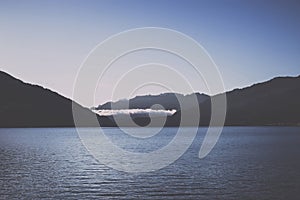 Panorama of Thun lake and away mountains in city Spiez, Switzerland