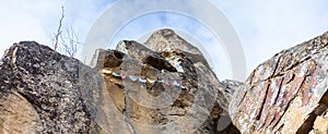 Panorama of Tibetan rocks with prayer flags. Adventure and religious journey