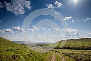 Panorama of Titelski breg, or titel hill, in Vojvodina, Serbia, with a dirtpath countryside road, in an agricultural landscape