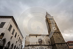 Panorama of the Titov trg square in Koper, Slovenia during a cloudy afternoon, with the Mestni Stolp city tower, the cathedral