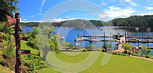 Panorama of Totem Pole overlooking Dock at Gorge Harbour, Cortes Island, Discovery Islands, British Columbia, Canada photo