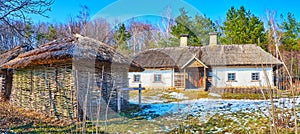 Panorama of traditional for Dnieper Ukraine  farmhouse hata and wooden barns in Pyrohiv Skansen, Kyiv, Ukraine