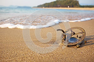 Panorama of tropical beach with old vintage sundial .