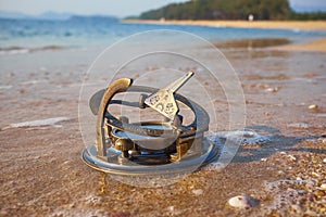 Panorama of tropical beach with old vintage sundial .