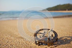 Panorama of tropical beach with old vintage sundial .