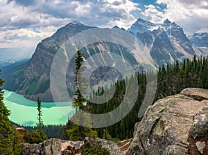 Panorama of turquoise Lake Louise and mountain range in Banff National Park. Hiking in Canadian Rockies. View from the top of Big