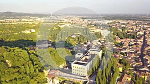Panorama of Verona historical city centre, bridges across Adige river. Medieval buildings with red tiled roofs, Italy.Aerial video