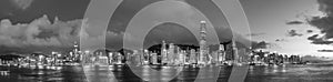 Panorama of Victoria harbor of Hong Kong city at dusk in monochrome