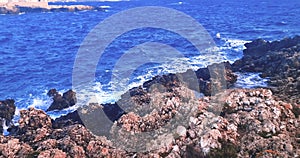 panorama view from above where the sea waves crashes on the rocky coast under a blue sky, concept of holiday, Porto Cesario Lecce