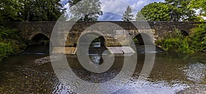 A panorama view across the bridge and ford in the town of Geddington, UK