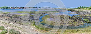 A panorama view across a marsh pool at low tide on the River Hamble