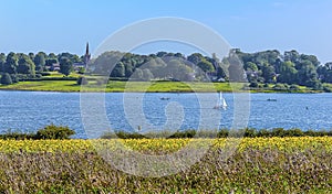 A panorama view across Rutland Water reservoir towards the village of Edith Weston