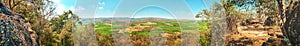 Panorama view of agriculture fields and forest with mountain in the background