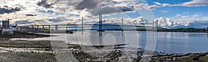 A panorama view along the shore at Queensferry towards the road bridges over the Firth of Forth, Scotland