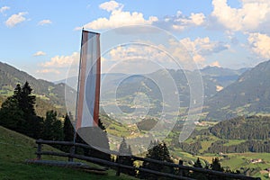 Panorama view with alpine mountains and austria flag in Salzburgerland, Austria