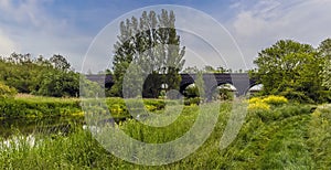 A panorama view from the banks of the River Nene towards the abandoned viaduct at Thrapston, UK