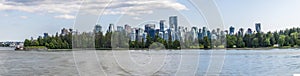 A panorama view from the bay across Stanley Park towards the skyline of Vancouver, Canada