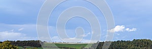 Panorama view Blue skyline with fram fields in spring or Summer, Landscape Green grass green trees with white Clouds and blue sky