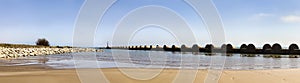 Panorama view of the breakwater in Les Salines beach in Cubelles, Barcelona, Spain.  Mediterranean summer day in Garraf coast