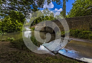 A panorama view of the bridge and ford over the River Ise in the town of Geddington, UK