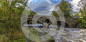 A panorama view of the bridge over the river Teifi at Cenarth, Wales after heavy rainfall