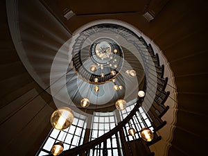 Panorama view of Cecil Brewer spiral staircase stairway hanging lights at Heals store London England Great Britain UK