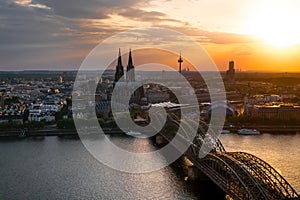 panorama view of Cologne Cathedral and Hohenzollern Bridge at sunset, Germany