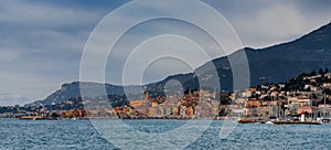 panorama view of the colorful old city center of Menton with the blue Mediterranenan Sea in the foreground