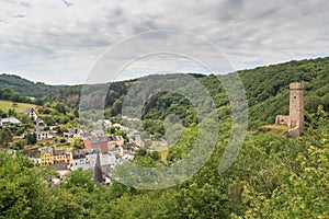 Panorama view of Eifel village Monreal and ruins of castle Philippsburg on a hill spur, Germany