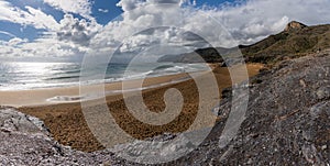 Panorama view of empty beaches and mountainous coast in Murcia under an expressive sky