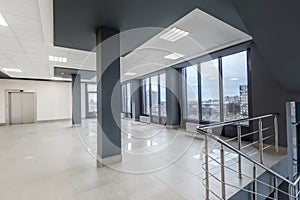 panorama view in empty modern hall with columns, doors, stairs and panoramic windows