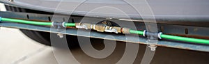 Panorama view flow control valves fill hose with spray nozzles front of street sweeper road cleaner truck with hydrant coupling,