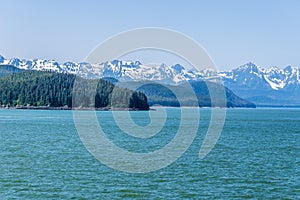A panorama view of the forested islets and mountain backdrop of the Gastineau Channel on the approach to Juneau, Alaska photo