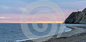 Panorama view of La Chucha Beach and the lighthouse of Cabo Sacratif in Andalusia at asunset photo