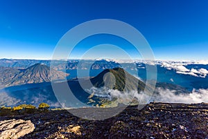 Panorama view of Lake Atitlan and volcano San Pedro and Toliman early in the morning from peak of volcano Atitlan, Guatemala. Hike