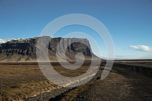 Panorama view of Lomagnupur table mountain subglacial mound rock formation ridge edge vertical cliff South Iceland